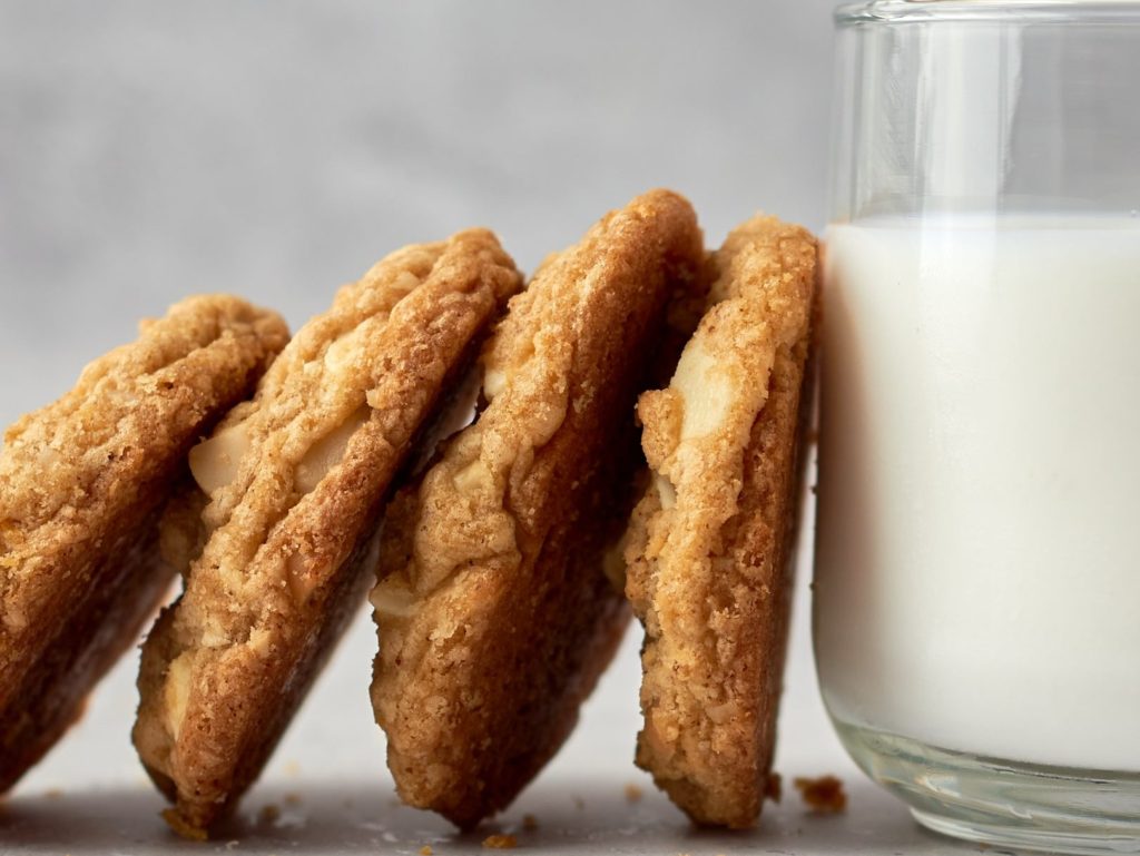 Cookies leaning on a glass of milk