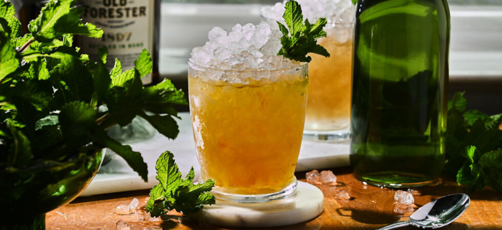 Mint Juleps, garnished with mint on a wooden coffee table