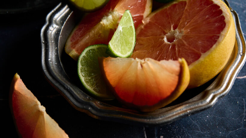 Rainwater Recipe: image is of cut grapefruit and limes in a decorative metal bowl. 