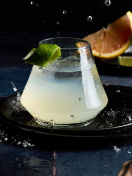 Mezcal Paloma Cocktail, titled Rainwater. Image shows water droplets falling and splashing around the cocktail