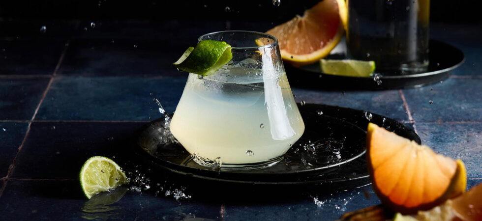 Mezcal Paloma Cocktail, titled Rainwater. Image shows water droplets falling and splashing around the cocktail