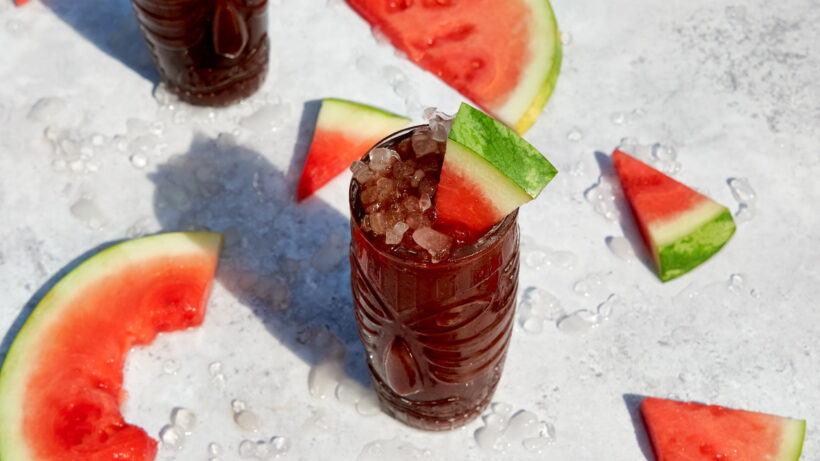 A Watermelon-Tamarind Cognac Cocktail in a tiki glass with pebble ice for a refreshing sipper.