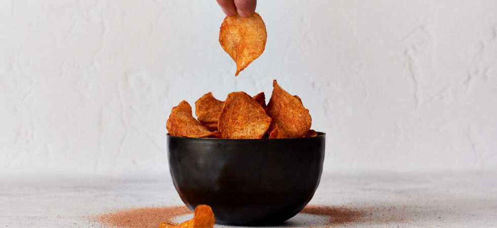 A small snacking bowl of barbecue potato chips.