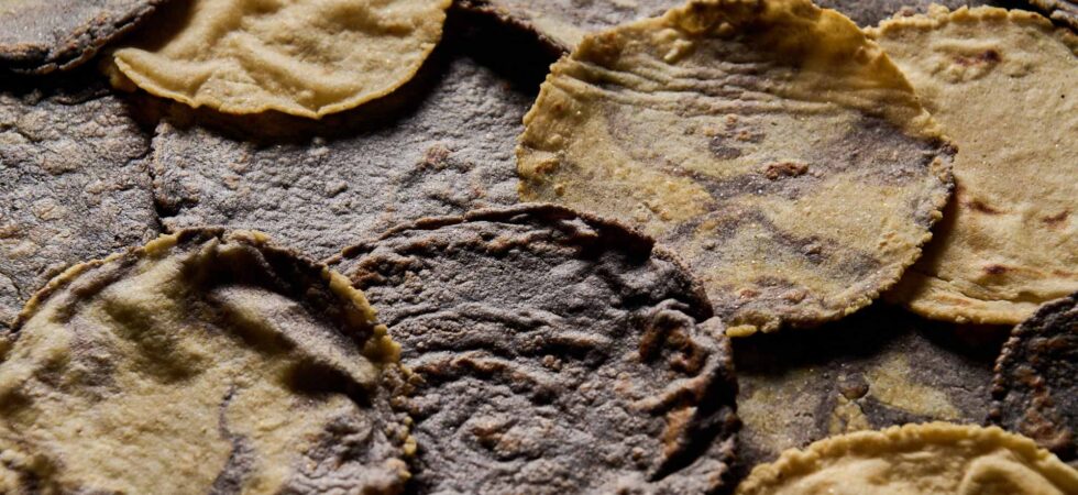 An overlapping pile of corn tortillas made with lard.