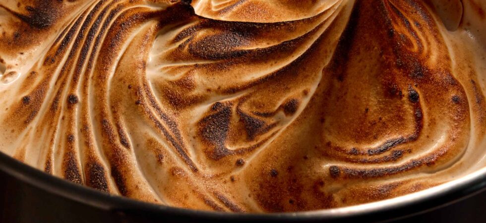 Marshmallow fluff in a mixing bowl that has been roasted.