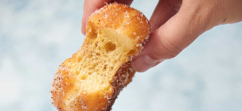 Brioche Donut with a bite taken out of it.