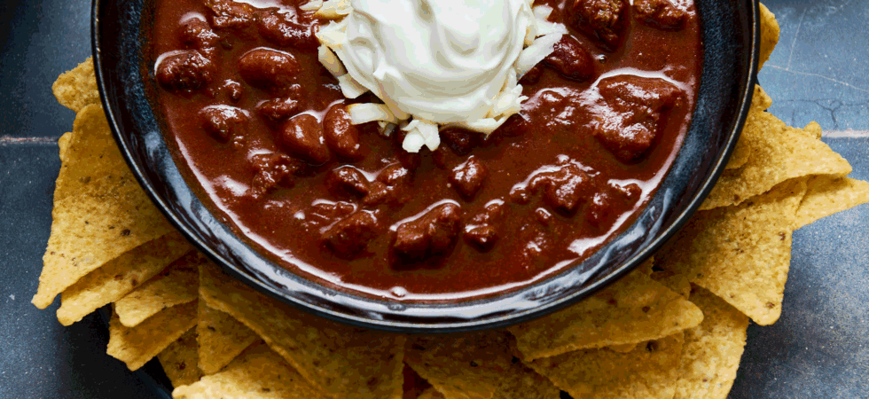 Bowl of chuck roast chili with toppings