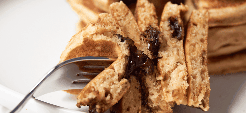 biteful of peanut butter chocolate chip pancakes on a fork.